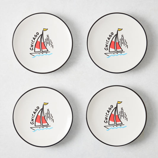 Set of four white appetizer plates with black rims and hand-painted Chicago sailboat illustrations by Rob Wilson.
