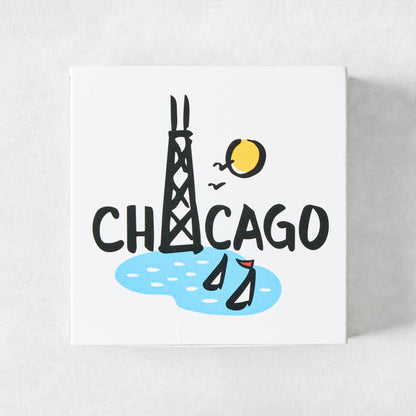 Square box of oversized matches featuring a Rob Wilson Chicago illustration with the Hancock Tower and sailboats.