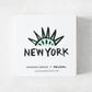 White square matchbox featuring a mint green Statue of Liberty crown illustration and New York text by Rob Wilson.