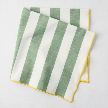 Rockport green and white stripe cotton napkin with yellow embroidered trim, folded.