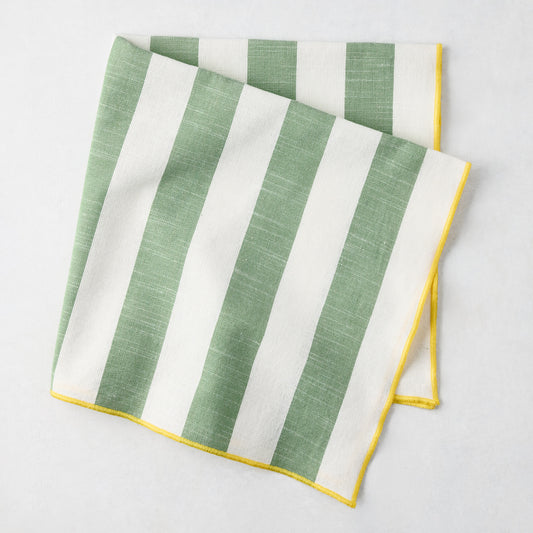 Rockport green and white stripe cotton napkin with yellow embroidered trim, folded.