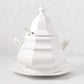 White ceramic Roma soup tureen with lid, spoon notch, handles, and matching octagonal base.