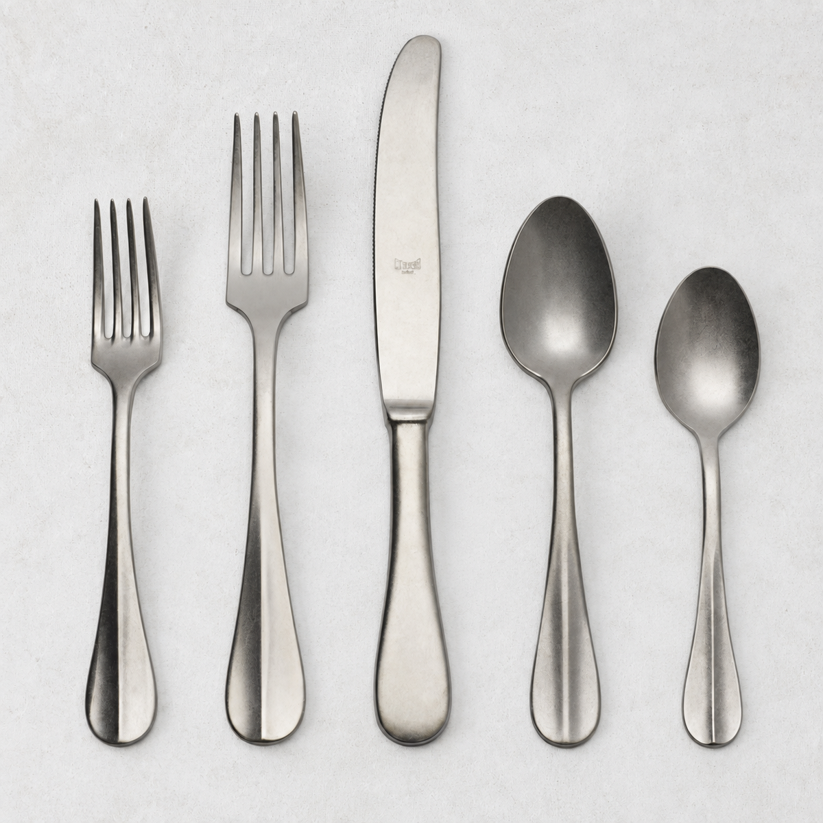 Roma Vintage 5-piece stainless steel flatware set with a matte finish, featuring a neo-baroque design on a white background.