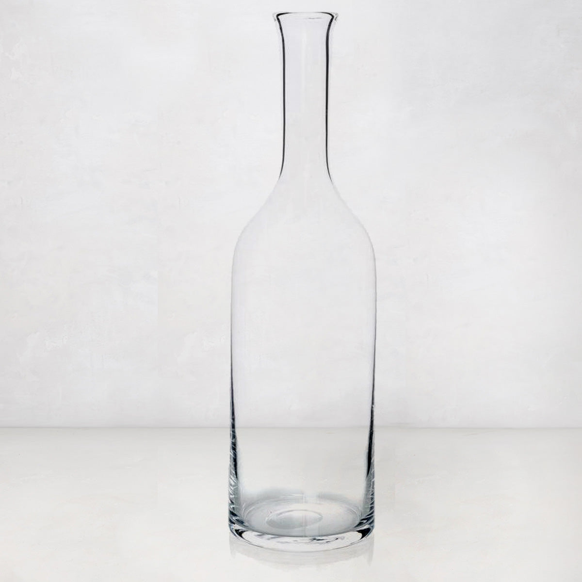 Clear, tall Romeo Scissor-Cut mouth-blown glass wine carafe with a narrow neck and wide base.