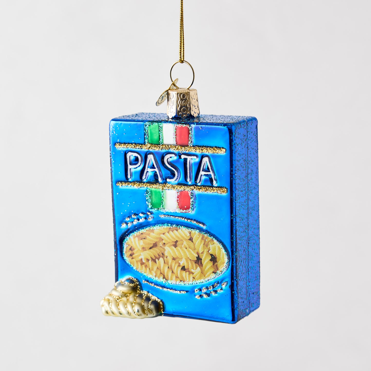 Blue glass rotini pasta box Christmas ornament with gold glitter accents and Italian flag detail.