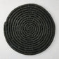 Round black woven abaca placemat, 15" Dia, with concentric spiral design.