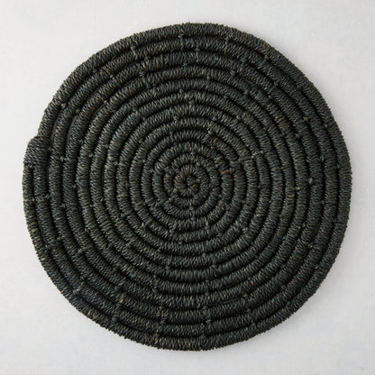 Round black woven abaca placemat, 15" Dia, with concentric spiral design.