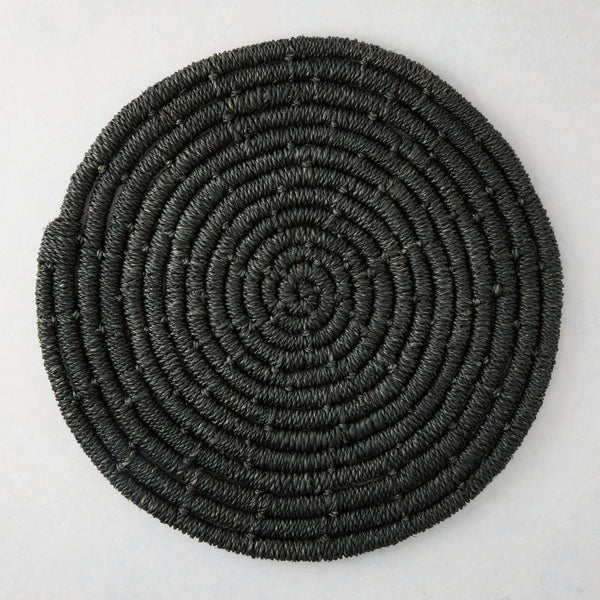 Round black woven abaca placemat, 15" Dia, with concentric spiral design.