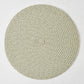 Round green and white tweed placemat with a coiled braided texture on a white background.