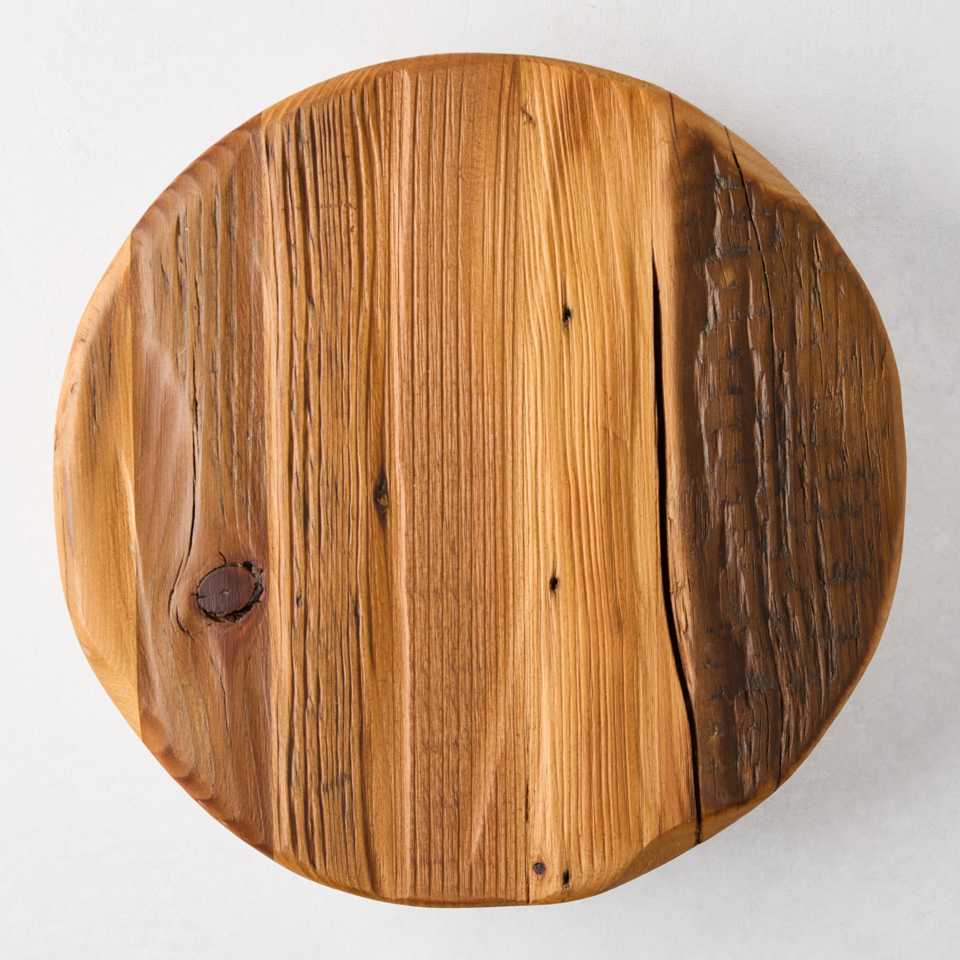 Round reclaimed pine wood footed trivet, 10"Dia, with natural grain and knots.