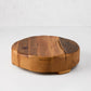 Round reclaimed pine wood footed trivet, 10"Dia x 3"H, with natural grain and visible cracks.