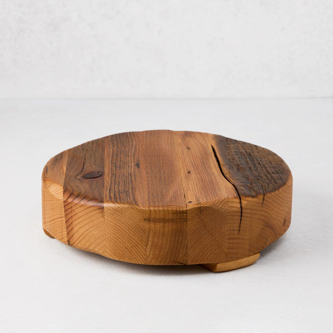 Round reclaimed pine wood footed trivet, 10"Dia x 3"H, with natural grain and visible cracks.