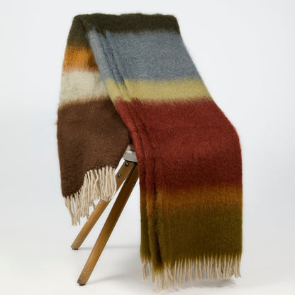 Handwoven Mantas Ezcaray Matisse mohair throw in rust, green, blue, and brown stripes with fringe, 79x51 inches.