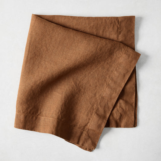 Rust brown hand-dyed linen dinner napkin with mitered corners, 22-inch square.