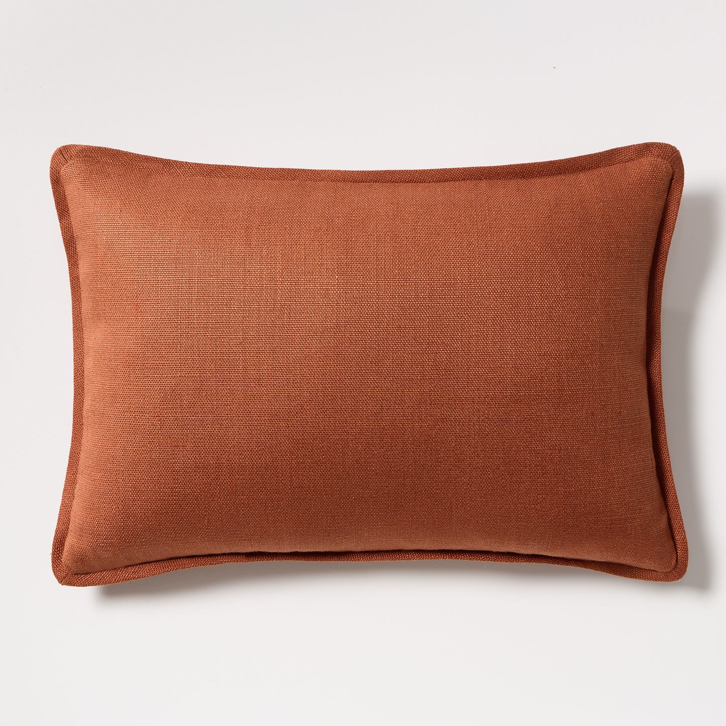 Rust orange tonal reversible velvet and linen lumbar pillow, 20x14 inches.