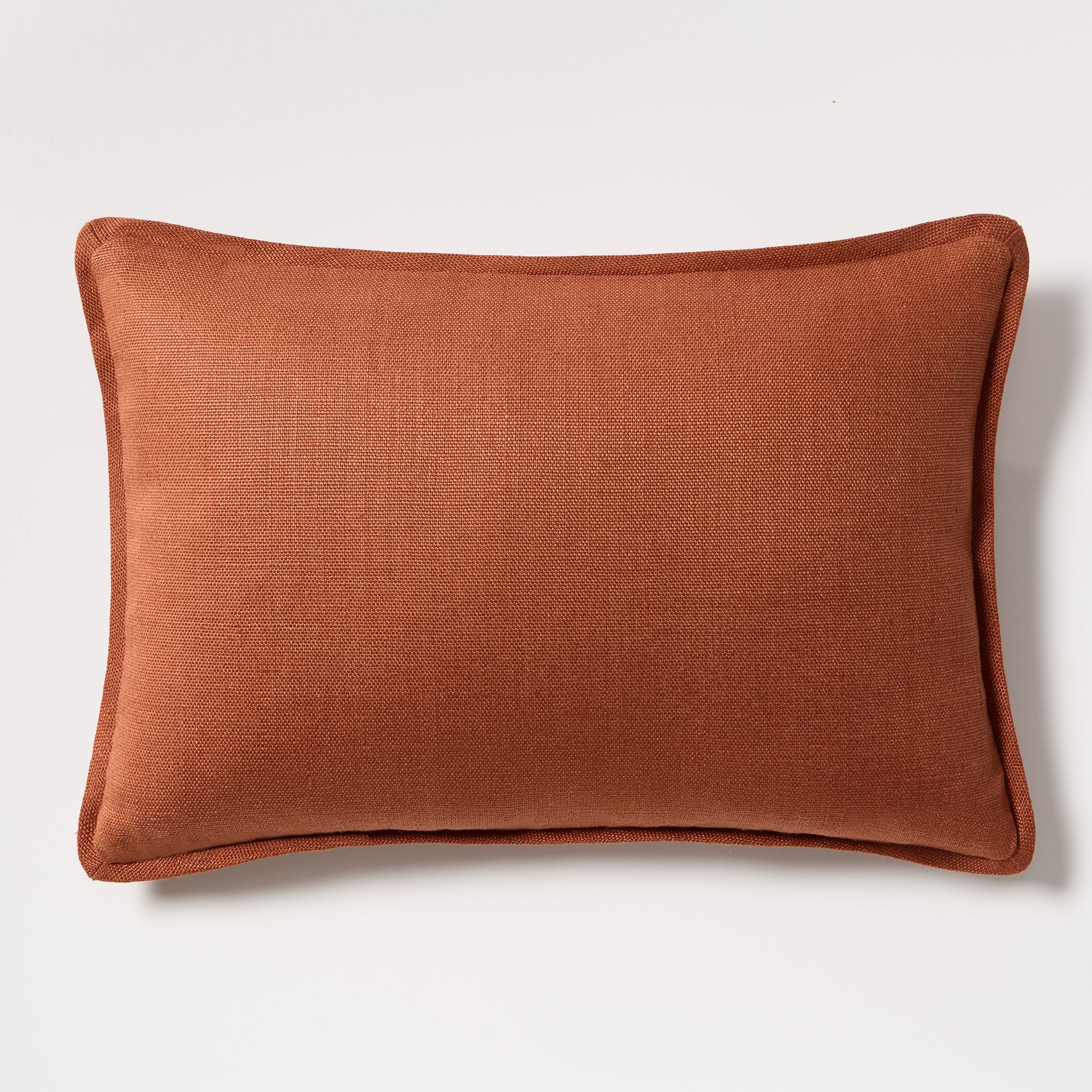 Rust orange tonal reversible velvet and linen lumbar pillow, 20x14 inches.