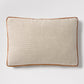 Linen lumbar pillow with rust orange velvet gusset and piping, 20"L x 14"H.