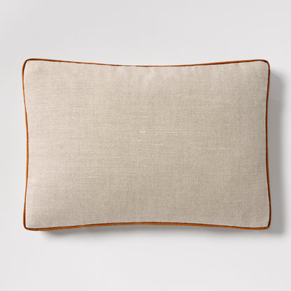 Linen lumbar pillow with rust orange velvet gusset and piping, 20"L x 14"H.