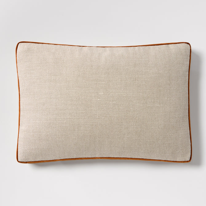 Linen lumbar pillow with rust orange velvet gusset and piping, 20"L x 14"H.