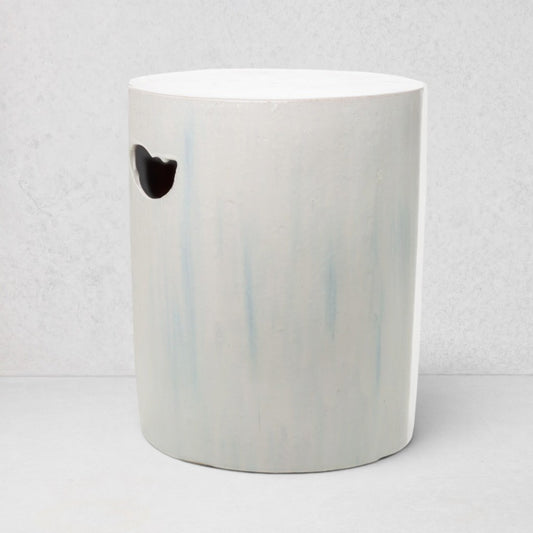 Rustic white ceramic cylinder garden stool with subtle blue streaks and a handle cutout.