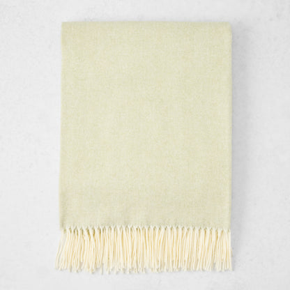 Sage Green Italian Herringbone Throw Blanket, cashmere-soft cotton-acrylic, with decorative fringe.