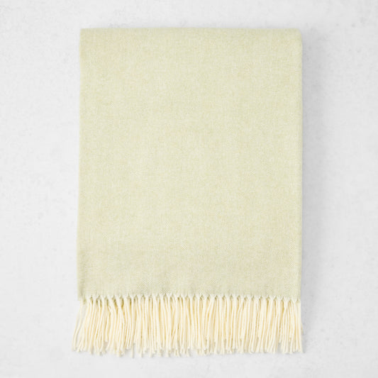 Sage Green Italian Herringbone Throw Blanket, cashmere-soft cotton-acrylic, with decorative fringe.