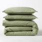 Sage green Italian percale duvet cover and two shams, folded and stacked.
