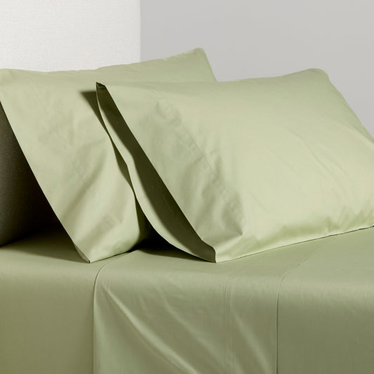 Sage green Italian percale sheet set with two pillowcases and flat sheet.