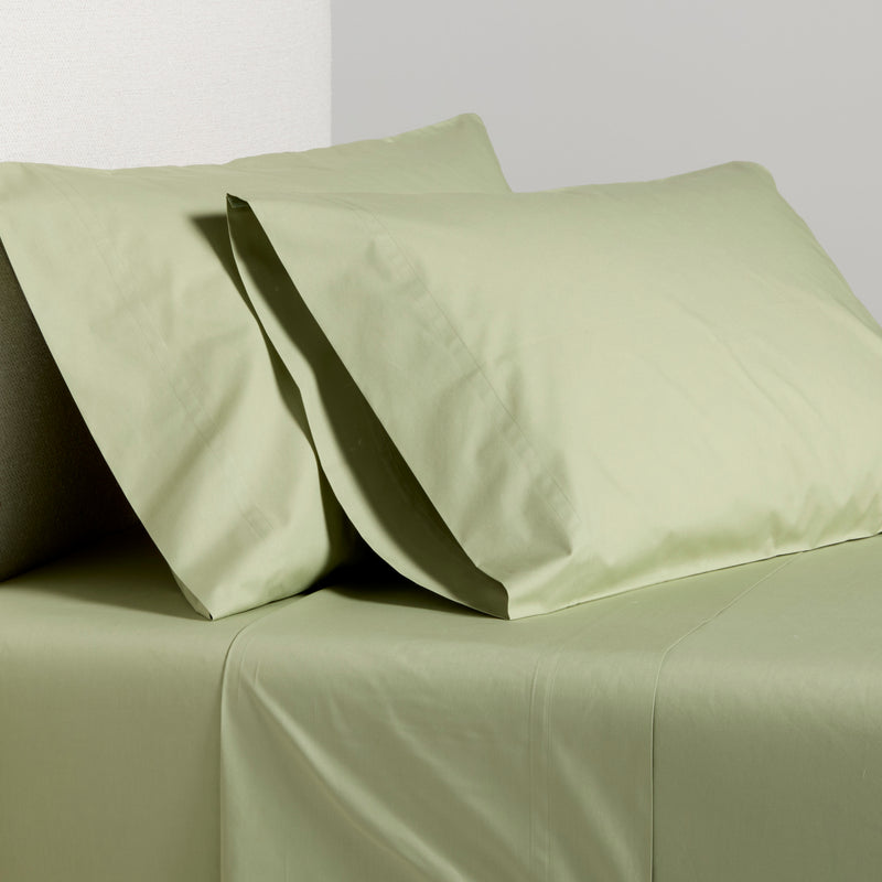 Sage green Italian percale sheet set with two pillowcases and flat sheet.