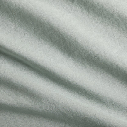 Sage green washed Italian linen duvet cover fabric with soft folds.