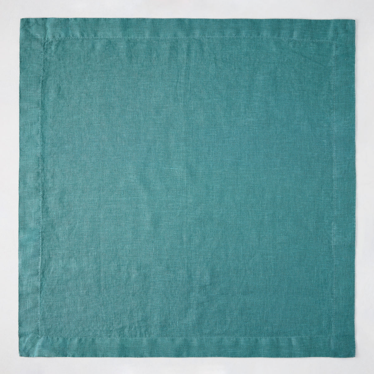 Sage HG Signature hand-dyed linen napkin, 22-inch square, earthy teal with mitered corners.