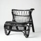 Black Saint Kitts Chair, natural rattan with curving silhouette, woven seat and back.
