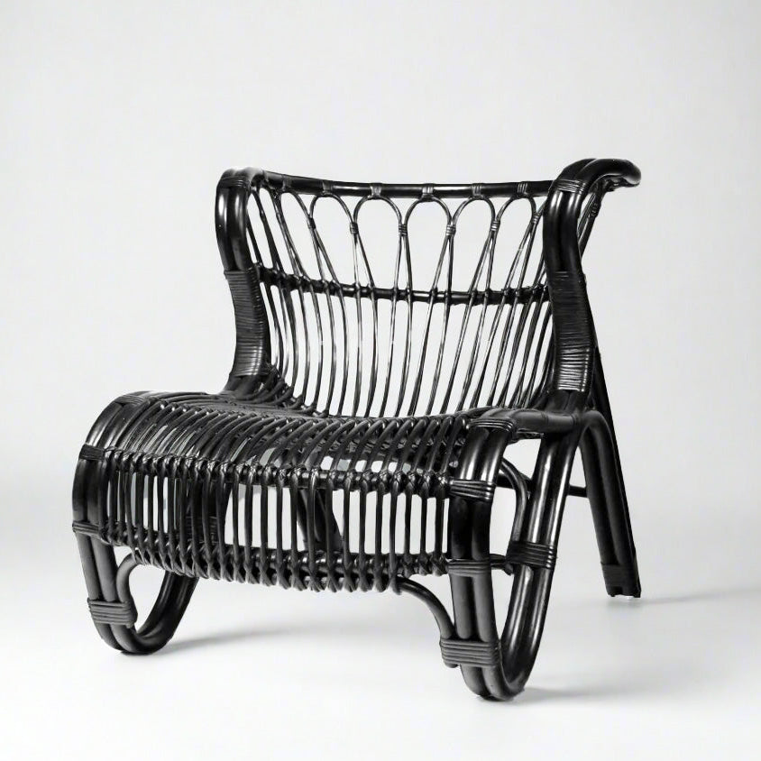 Black Saint Kitts Chair, natural rattan with curving silhouette, woven seat and back.