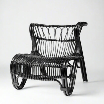 Black Saint Kitts Chair, natural rattan with curving silhouette, woven seat and back.