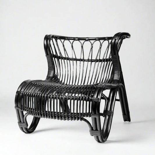 Black Saint Kitts Chair, natural rattan with curving silhouette, woven seat and back.