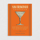 Orange San Francisco Cocktails book with a martini glass silhouette revealing a map of the Golden Gate.