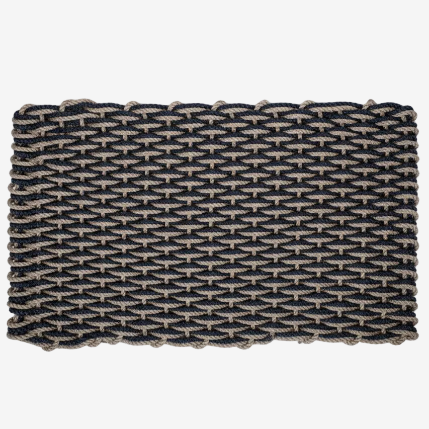 Handwoven Sand and Navy Braided Rope Doormat with a tight, textured weave.