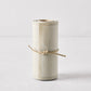 Roll of 50 sand-colored tear-off cotton cocktail napkins, tied with natural twine.