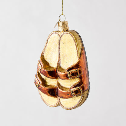 Hand-painted glass and resin sandal ornament in metallic bronze and glittery tan with gold buckles.