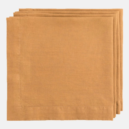 Stacked Sandalwood HG Signature hand-dyed 22-inch linen napkins with mitered corners.