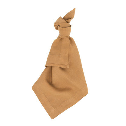 Sandalwood HG Signature hand-dyed linen napkin, 22" square, tied in a knot, on a white background.
