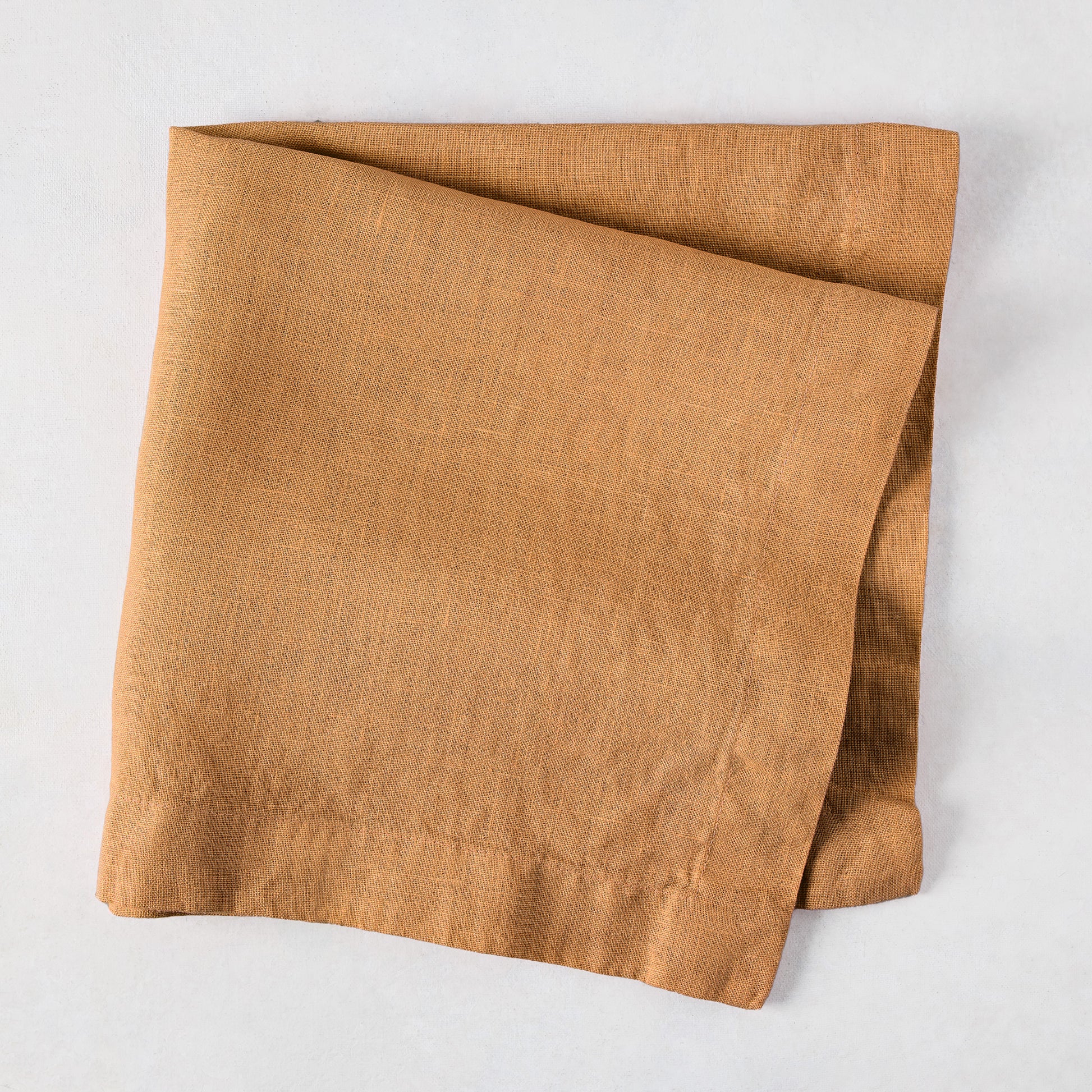 Sandalwood HG Signature hand-dyed linen napkin, 22-inch square, folded, with mitered corners.