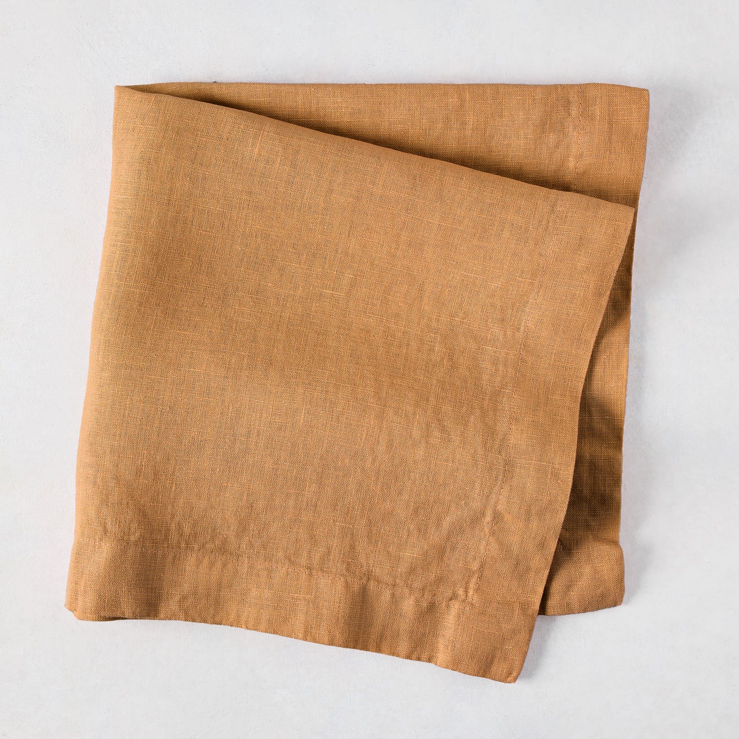 Sandalwood HG Signature hand-dyed linen napkin, 22-inch square, folded, with mitered corners.