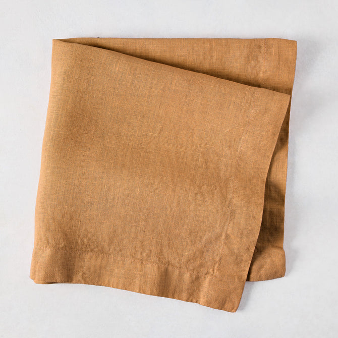 Sandalwood HG Signature hand-dyed linen napkin, 22-inch square, folded, with mitered corners.