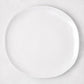 Sandia White 11" round melamine dinner plate with matte exterior and glossy interior.