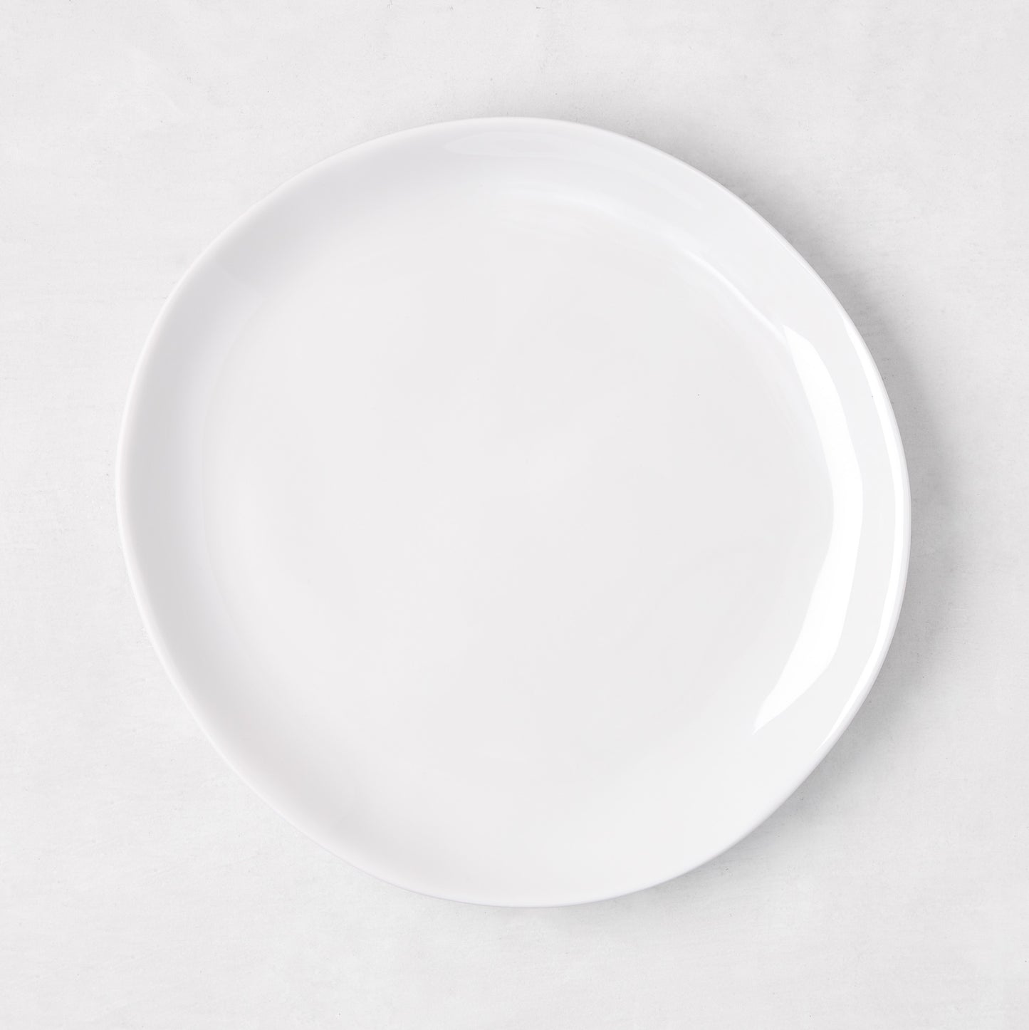 Sandia White 7.75" melamine salad plate with organic, hand-thrown-inspired curves.