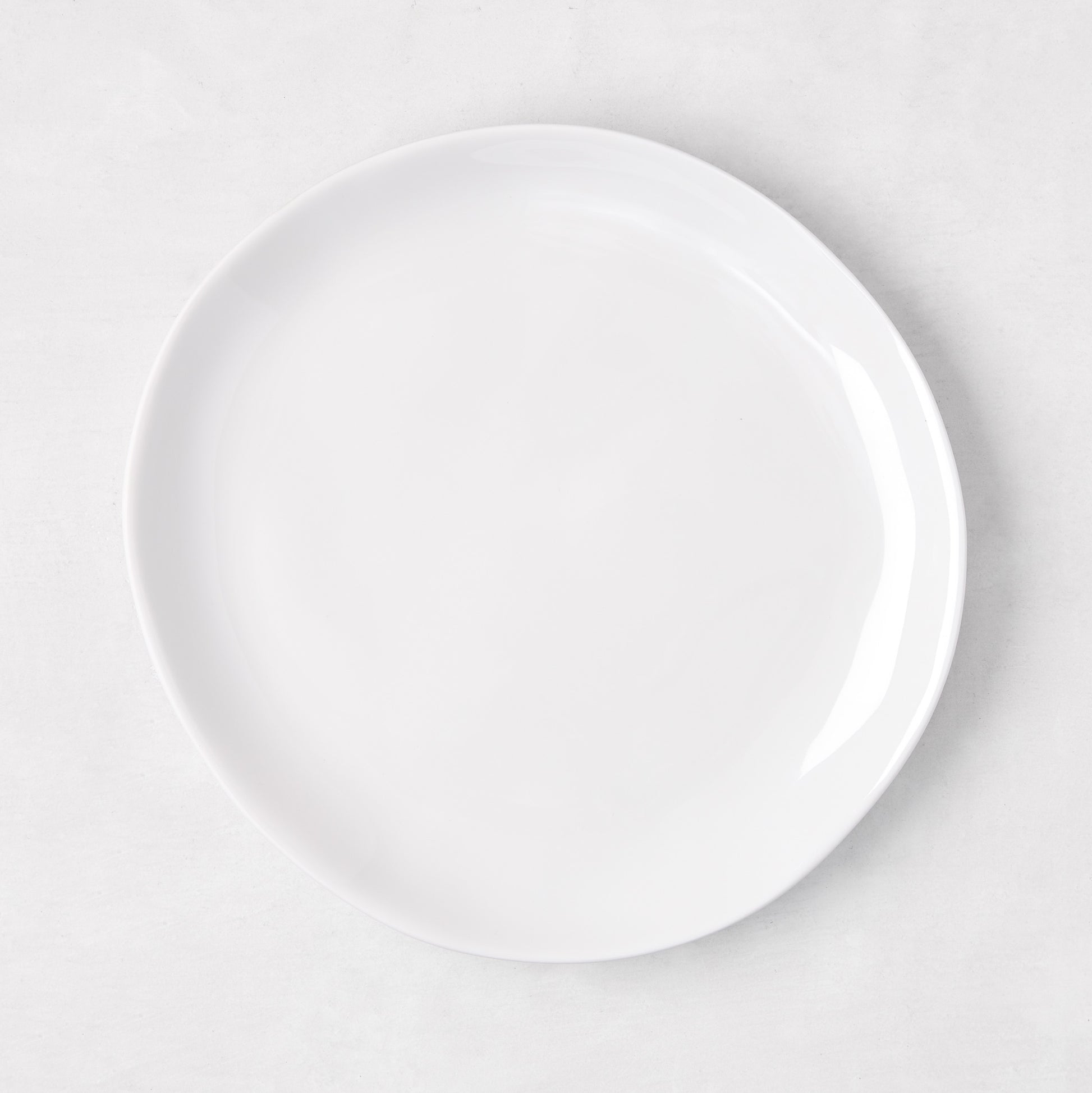 Sandia White 7.75" melamine salad plate with organic, hand-thrown-inspired curves.