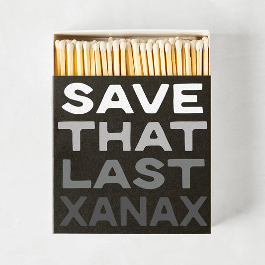 Black oversized matchbox with "SAVE THAT LAST XANAX" in white and gray text, filled with long wooden matches.