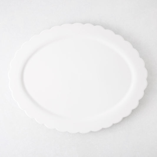 White ceramic Scallop Oval Serving Platter, 17.72"L x 14.17"W, with a subtle scalloped edge.