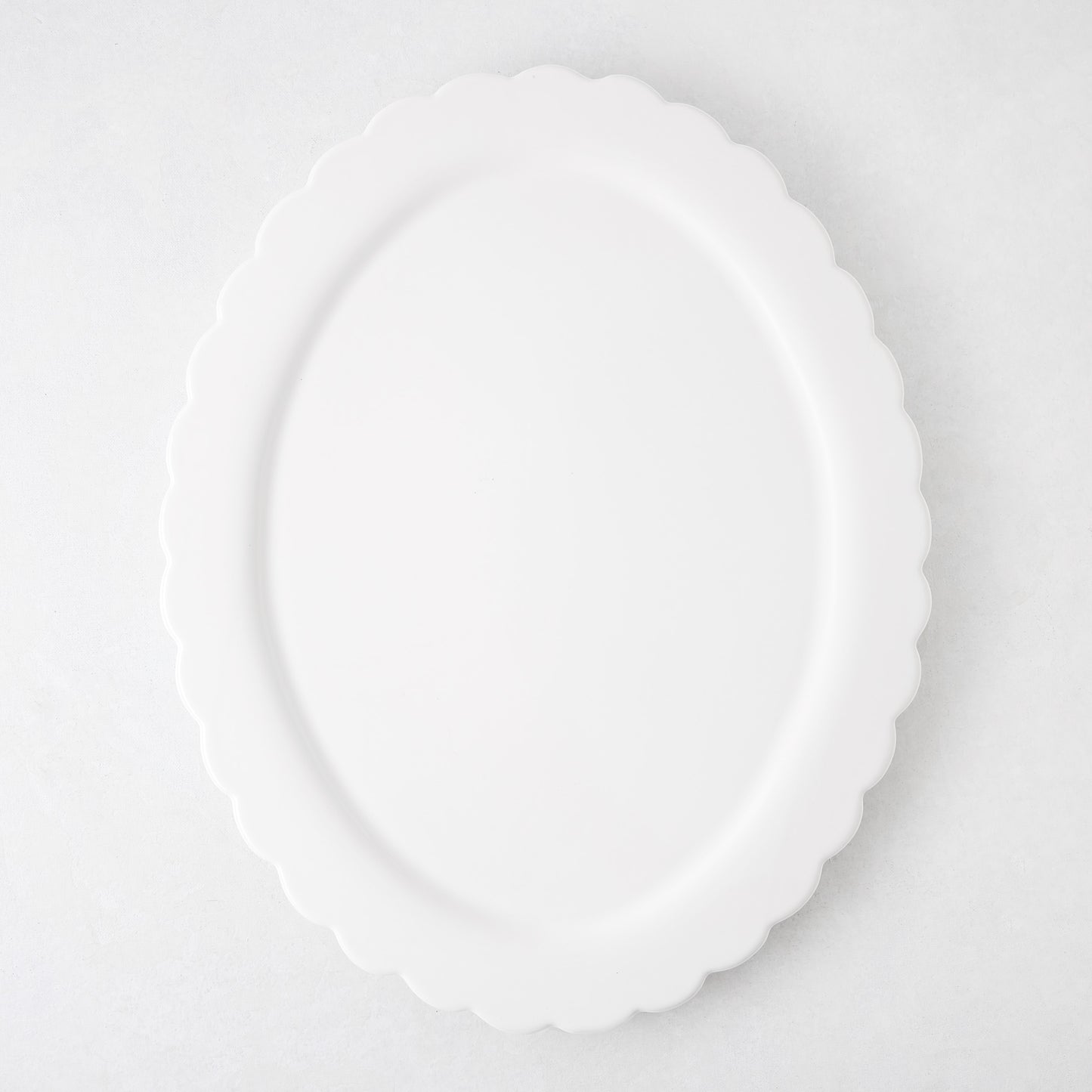 White ceramic Scallop Oval Serving Platter, 17.72"L x 14.17"W, with a scalloped edge.